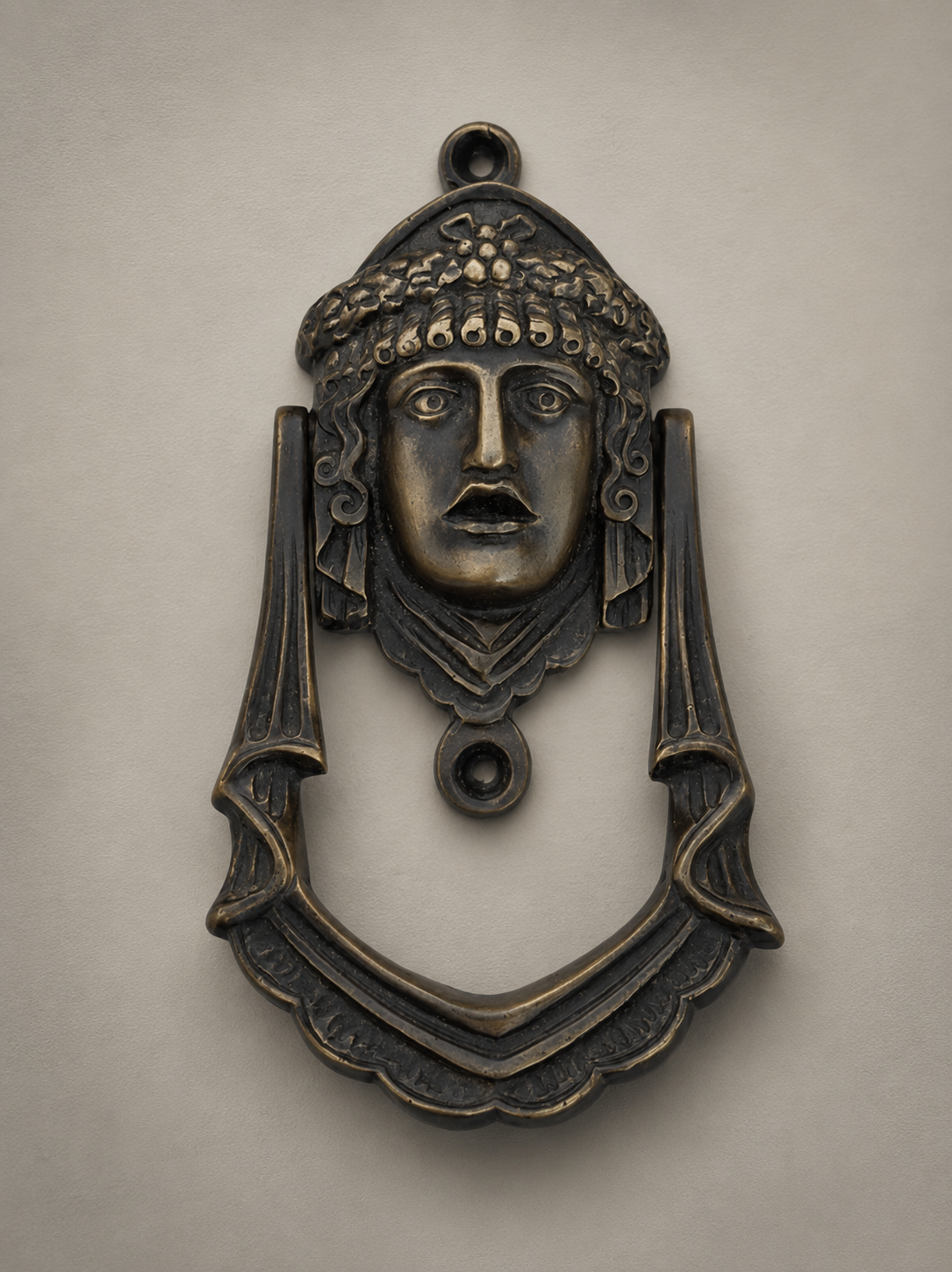 Antique brass door knocker with detailed face